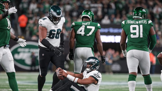Jets' DE Bryce Huff (47) walks away after sacking Eagles' QB Jalen Hurts
